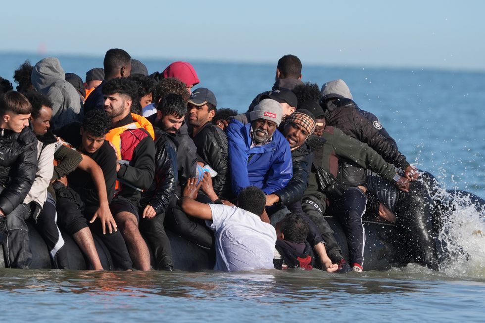 \u200bMigrants struggling to board a small boat bound for Britain