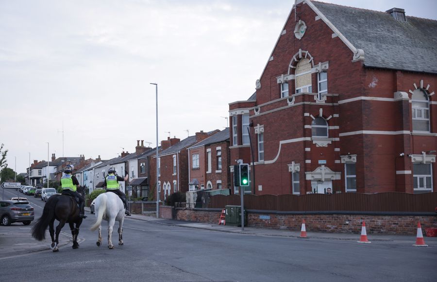 \u200bMounted police officers patrol outside Southport Islamic Centre Mosque in Southport