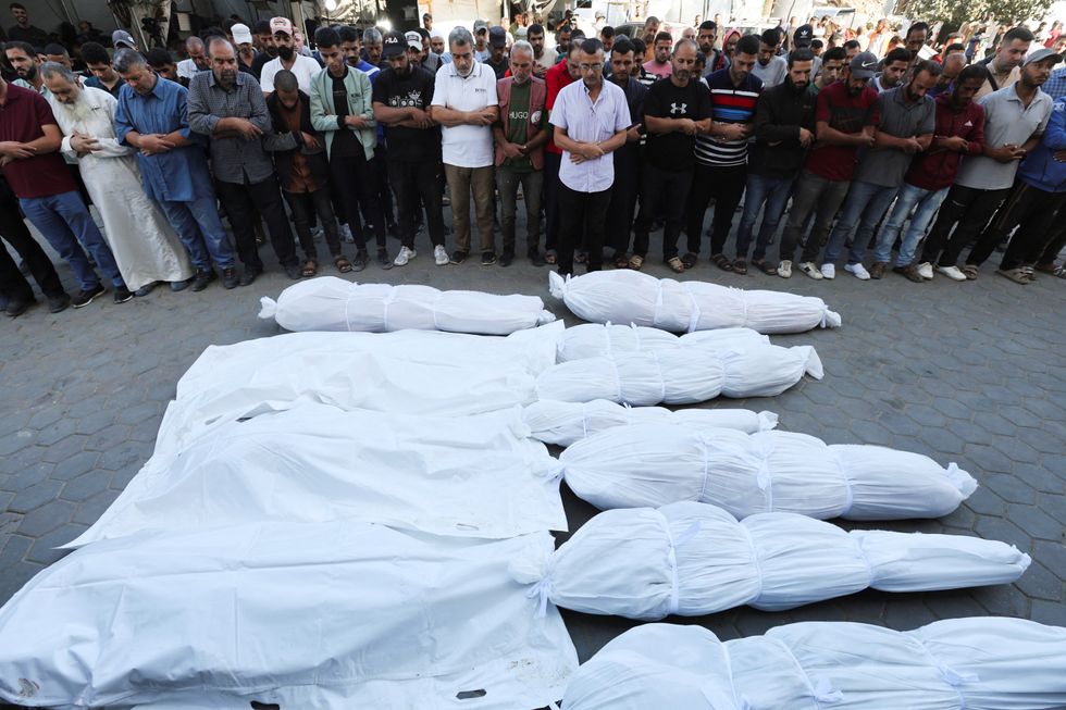 \u200bMourners react near the bodies of Palestinians, who were killed in an Israeli strike, amid the Israel-Hamas conflict, at Al-Aqsa Martyrs Hospita