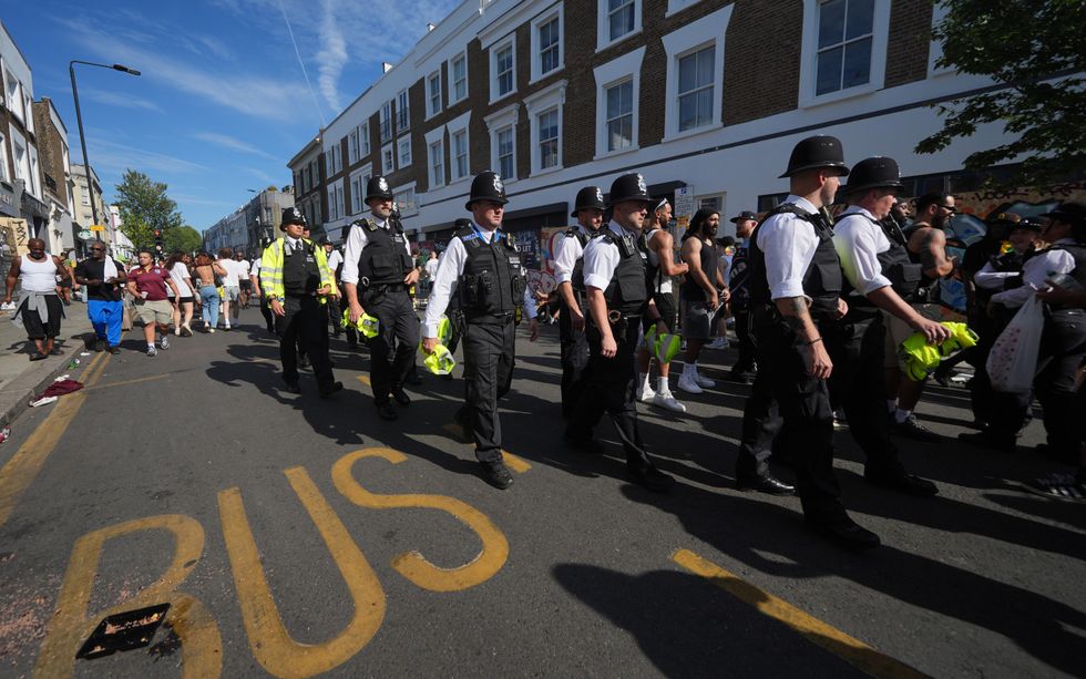 \u200bMultiple police officers can be seen marching at the Carnival