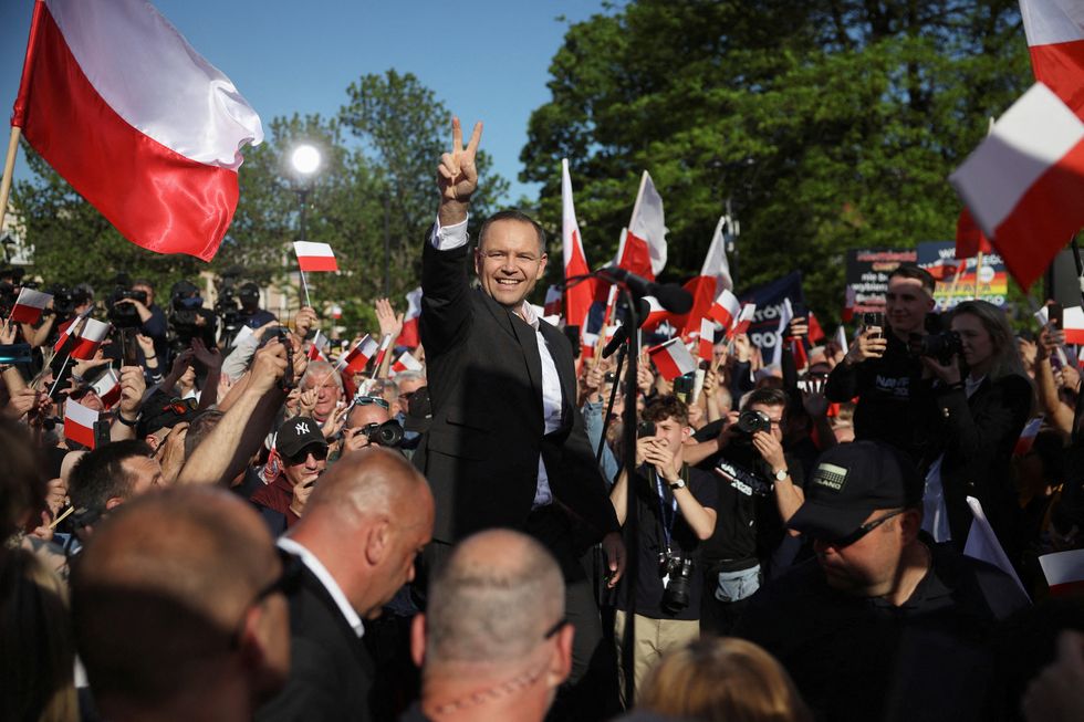 \u200bNawrocki, backed by the main opposition Law and Justice (PiS) party, gestures during his final rally