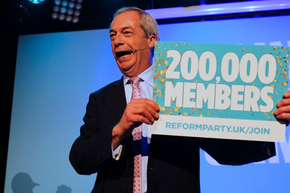 \u200bNigel Farage appeared on stage with a placard celebrating the major milestone