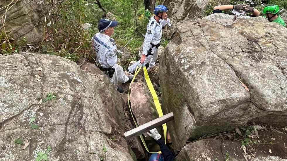 \u200bNSW police seen moving a massive boulder to free the woman