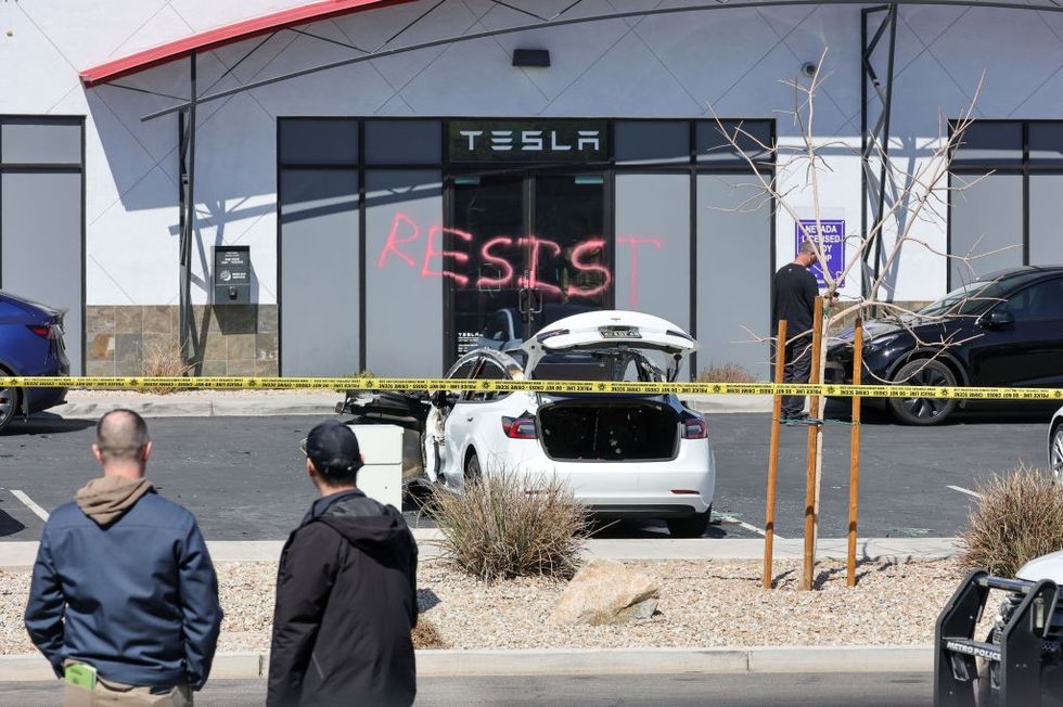 \u200bnvestigators look over the scene at a Tesla Collision Center after an individual used incendiary devices to set several vehicles on fire on March 18, 2025 in Las Vegas, Nevada.