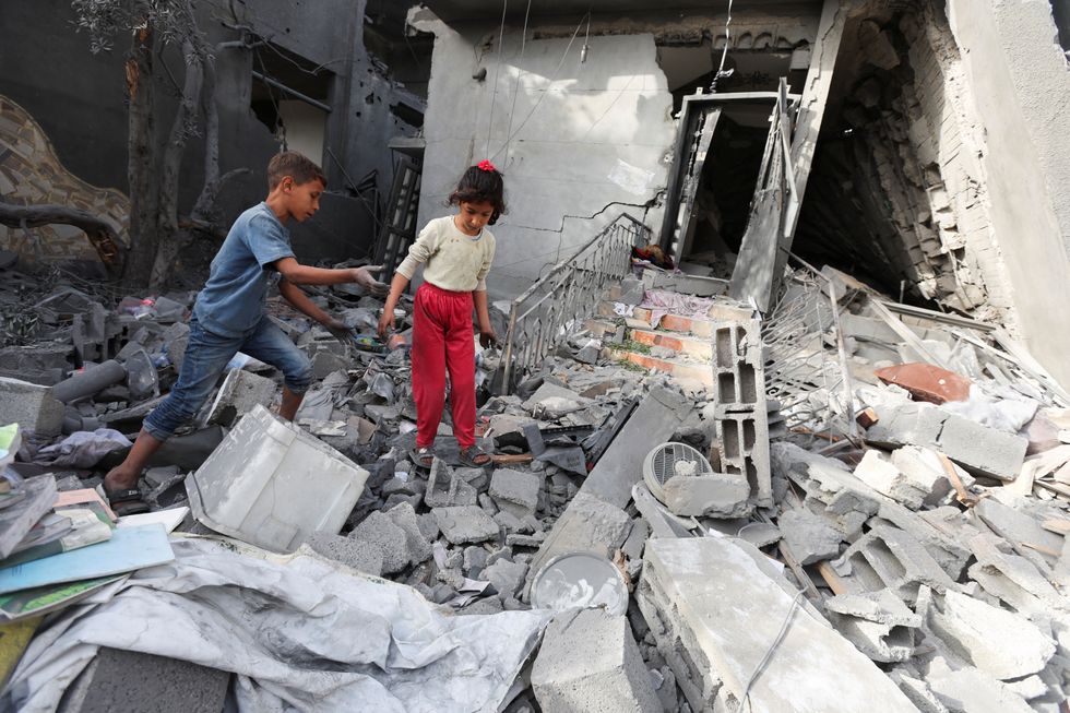 \u200bPalestinian children inspect the site of an Israeli strike on a house, in Deir Al-Balah in the central Gaza Strip