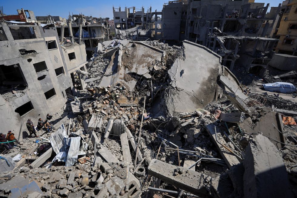 \u200bPalestinians gather at the site of an Israeli strike on a house, in Gaza City