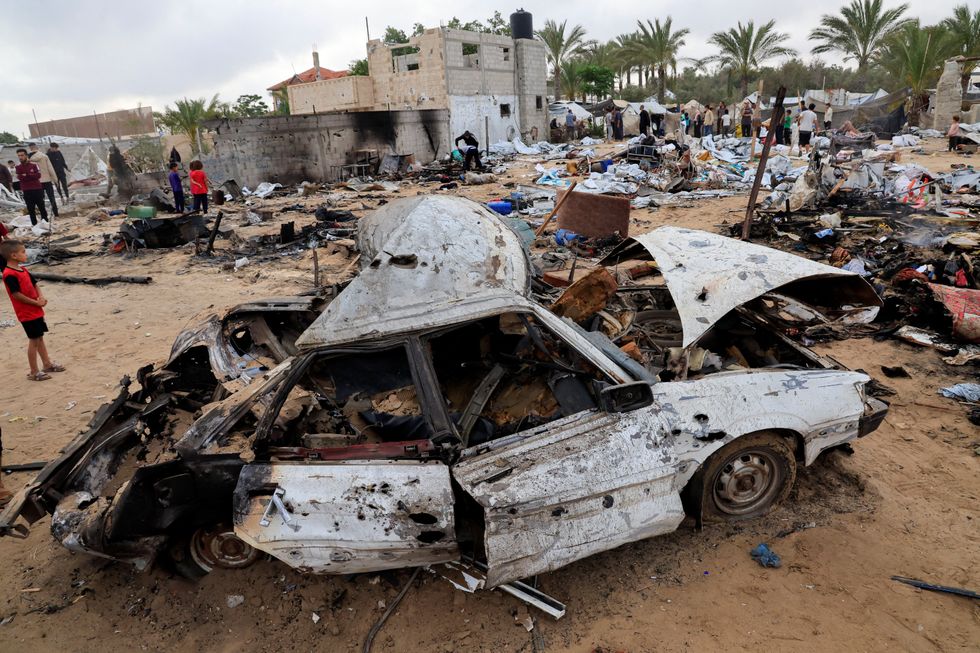 \u200bPalestinians inspect the damage at the site of an Israeli strike on a tent camp sheltering displaced people, in Khan Younis