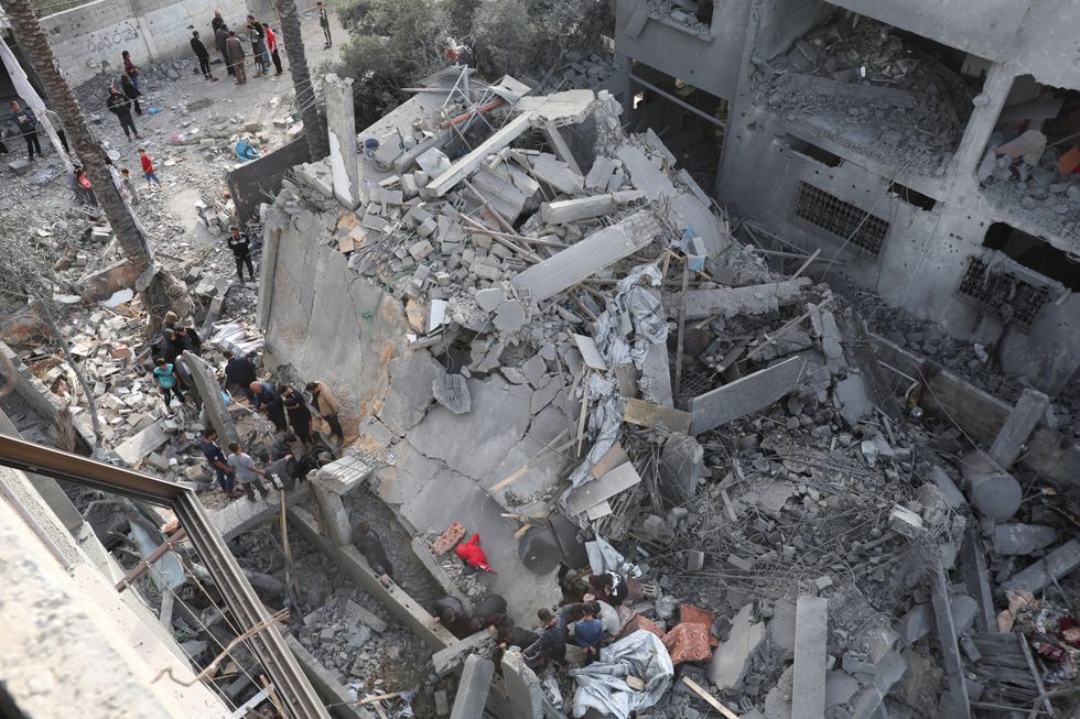 \u200bPalestinians inspect the site of an Israeli strike on a house,