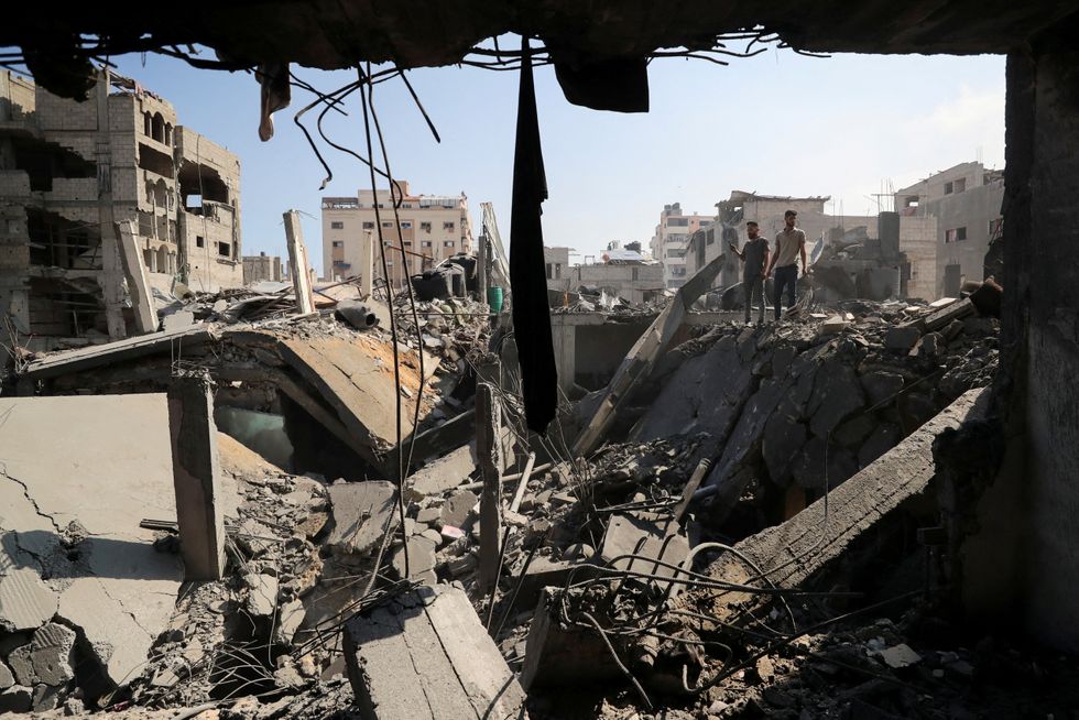 \u200bPalestinians inspect the site of Thursday's Israeli strike on Gaza City