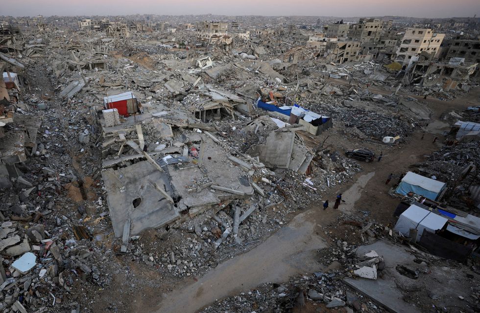 \u200bPalestinians stand near rubble from destroyed buildings, amid a ceasefire between Israel and Hamas, in Gaza City,