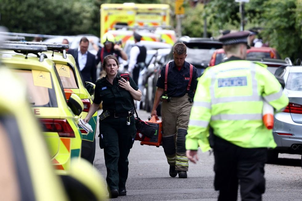 \u200bParamedics and police officers walk near the private Study Prep girls' school