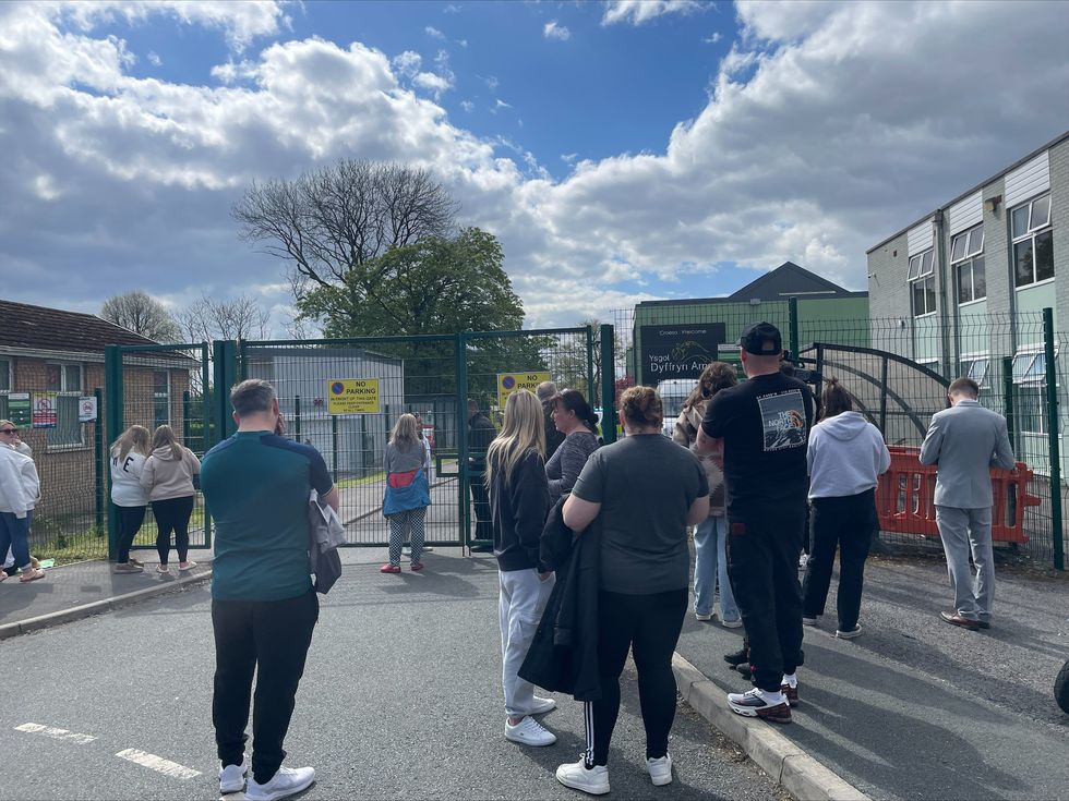 \u200bParents wait at the gates of Amman Valley school, in Ammanford, Carmarthenshire