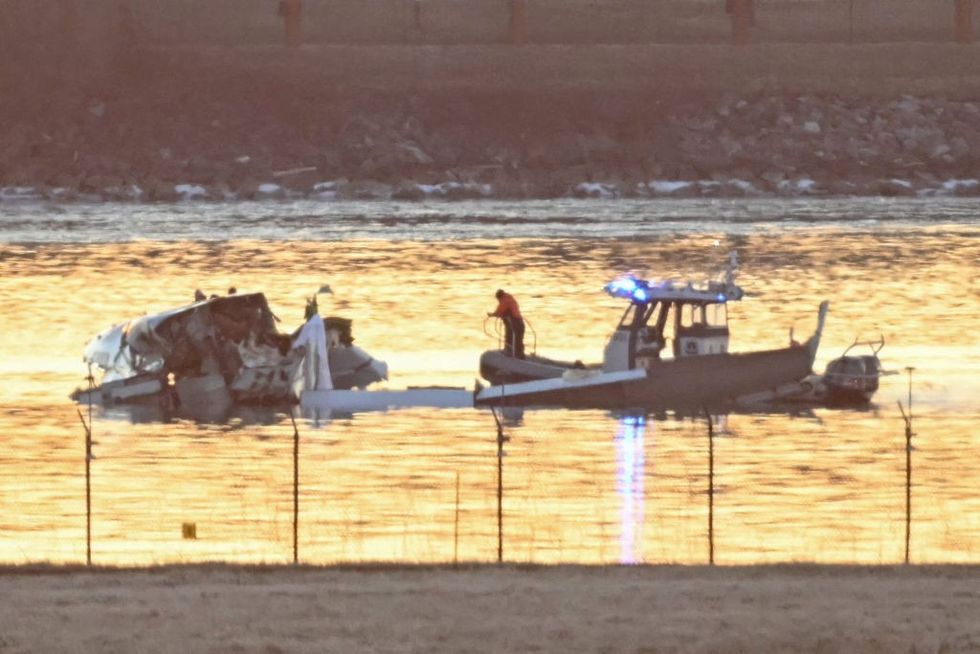 \u200bPart of the wreckage is seen as rescue boats search the waters