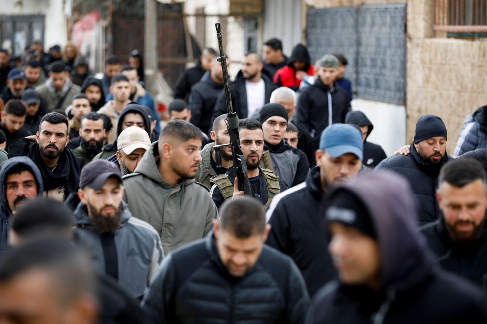 \u200bPeople attend the funeral of three Palestinians that were killed during an Israeli raid in a hospital, in Jenin
