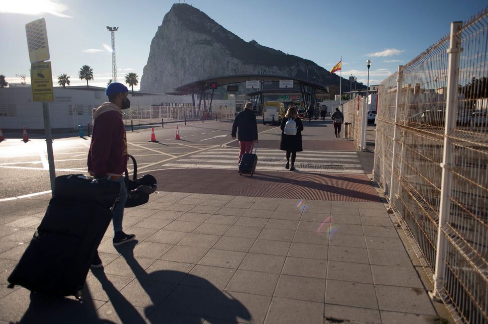\u200bPeople cross the border between Spain and Gibraltar at La Linea de la Concepcion