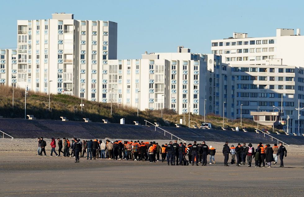 \u200bPeople escorted from the beach after failing to board a small boat off the coast of Dunkirk, France