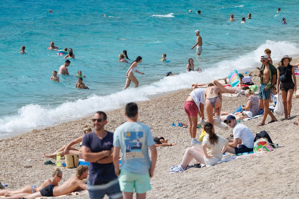 \u200bPeople sunbathe at the Zlatni Rat beach on the island of Brac, Croatia