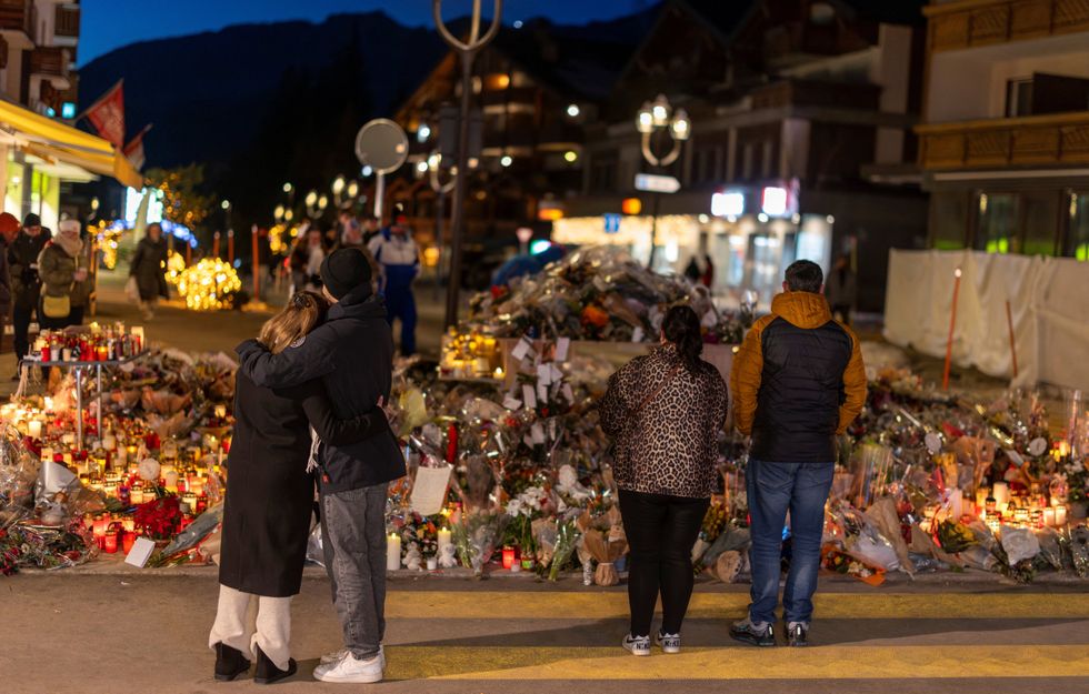 \u200bPeople visit a makeshift memorial outside the "Le Constellation" bar,