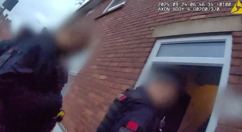 \u200bPolice entering a property in Oldham before making an arrest on Wednesday