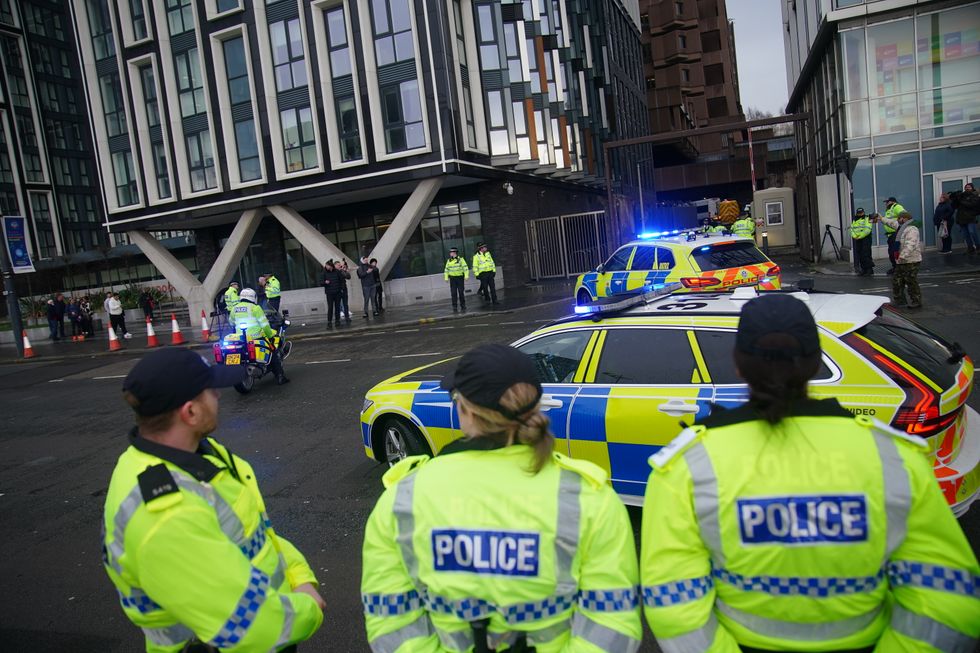 \u200bPolice escort a prison van believed to contain Axel Rudakubana arriving at Liverpool Crown Court