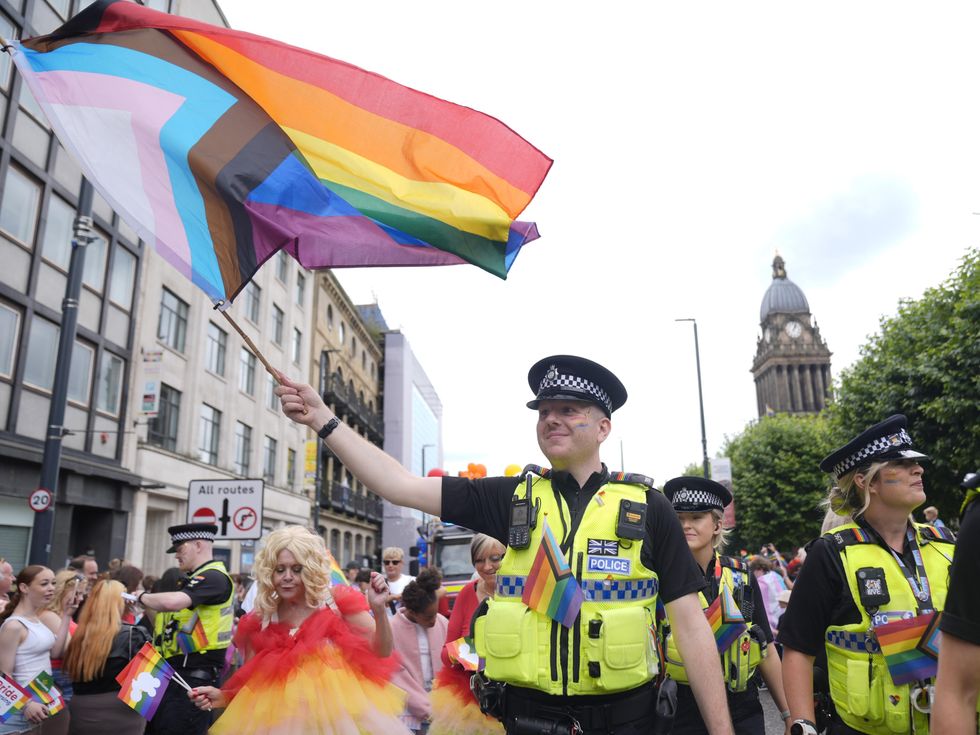 \u200bPolice officer waving pride flag in Leeds