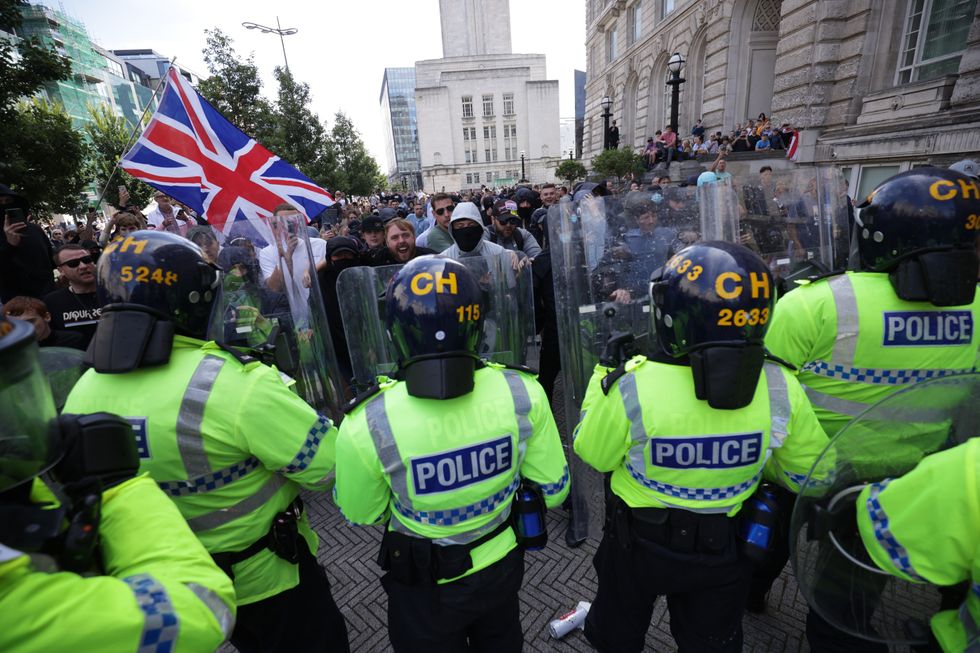 \u200bPolice officers face protesters in Liverpool