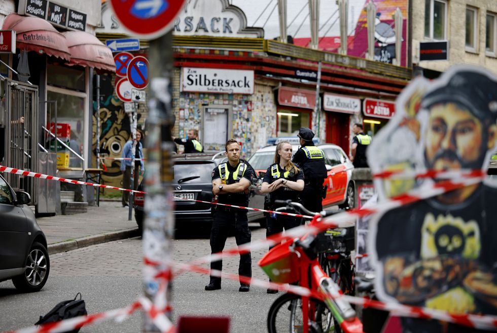 \u200bPolice officers guard a cordoned off area on Silbersackstrasse