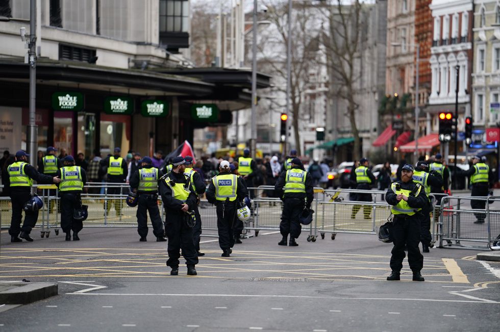 \u200bPolice officers inside the cordon at the Israeli embassy in Kensington High Street,