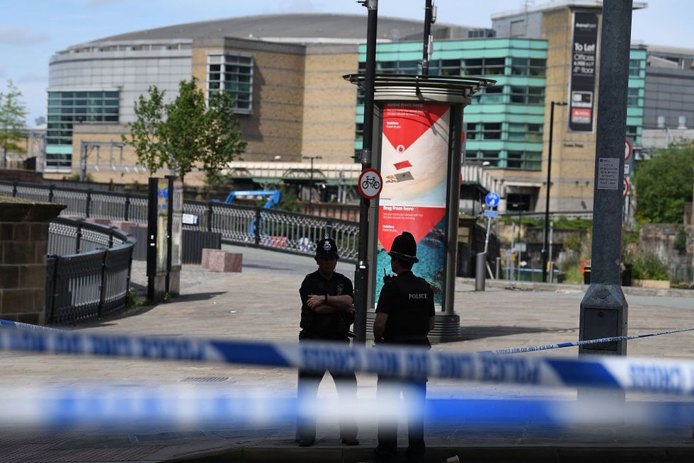 \u200bPolice stand guard near the Manchester Arena on May 23, 2017 in Manchester