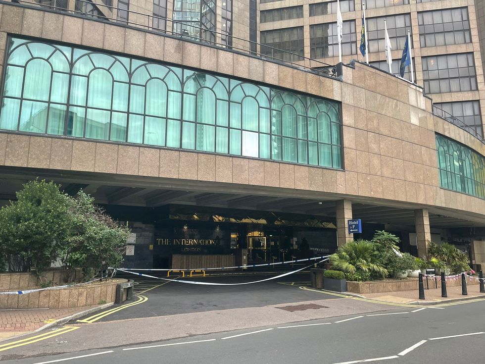 \u200bPolice tape and a lone vehicle at Britannia International Hotel