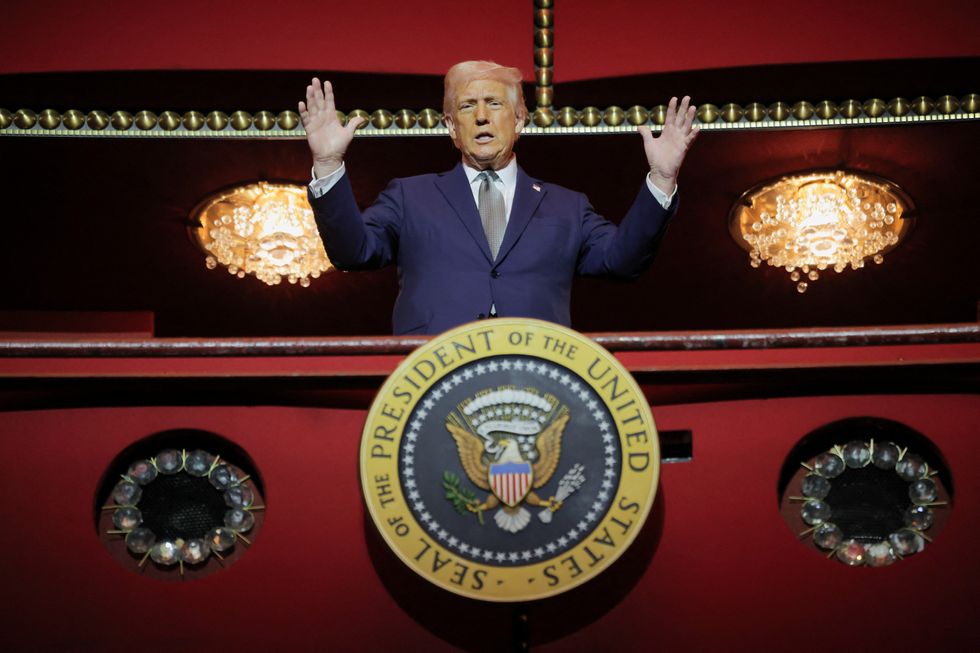 \u200bPresident Donald Trump gestures while he poses for a picture at the presidential box at the Kennedy Center,