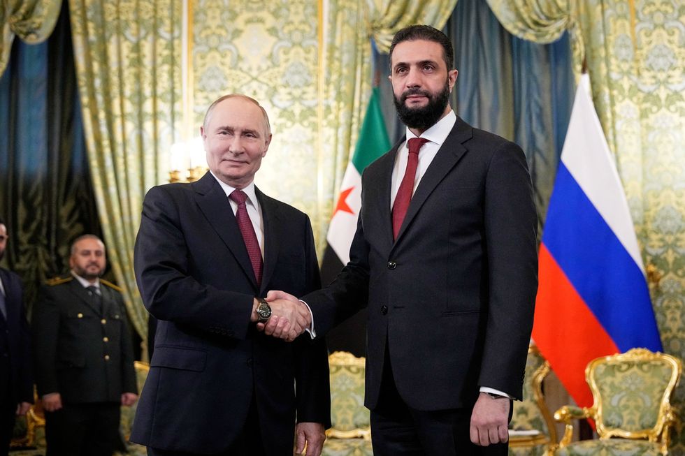 \u200bPresident Vladimir Putin shakes hands with Syria's President Ahmed al-Sharaa