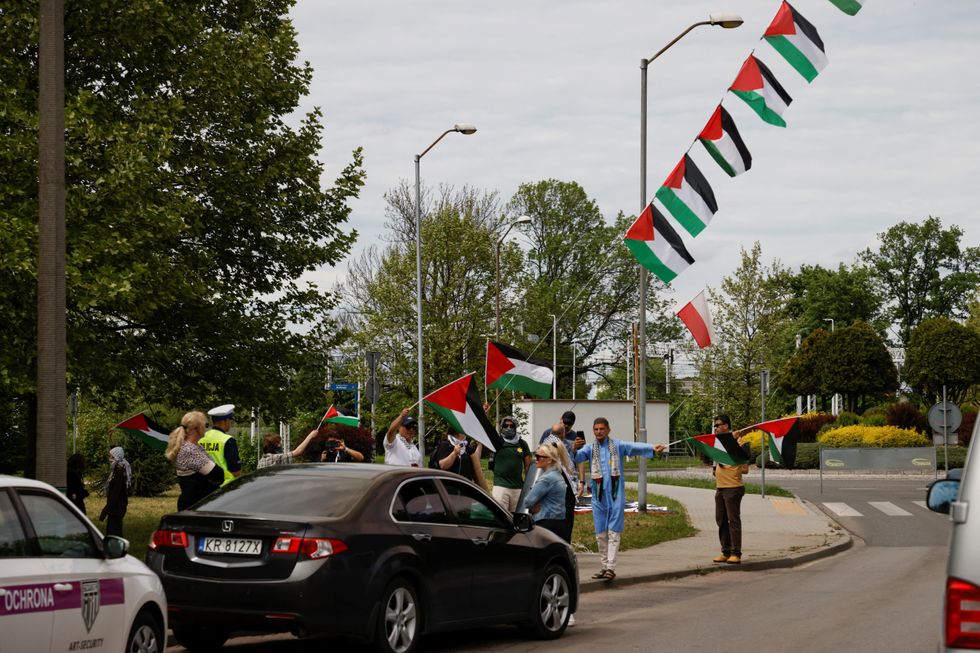\u200bPro-Palestinian protesters hold flags on the route of the annual International March of the Living