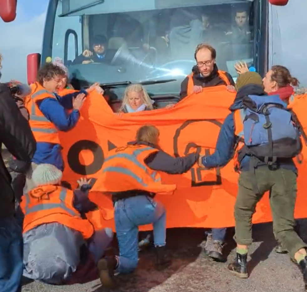 \u200bProtesters blocking the bus