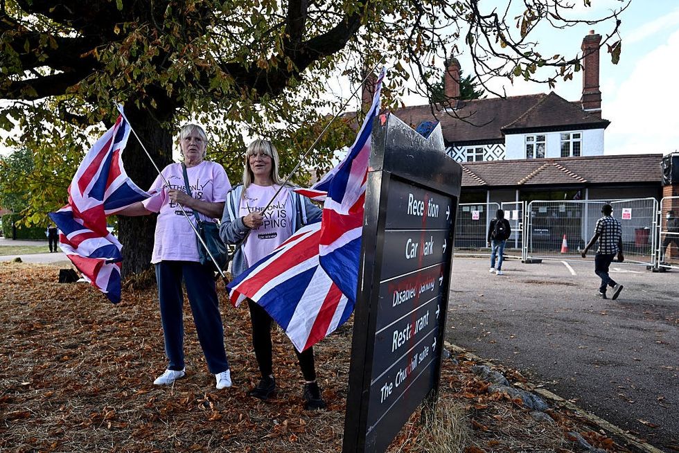 \u200bProtesters gather outside The Bell Hotel after the Court of Appeal overturned order to evict asylum seekers