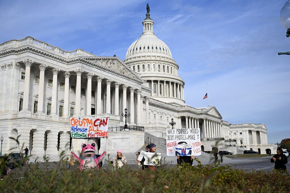 \u200bProtesters hold signs before a press conference on the Epstein Files Transparency Act,