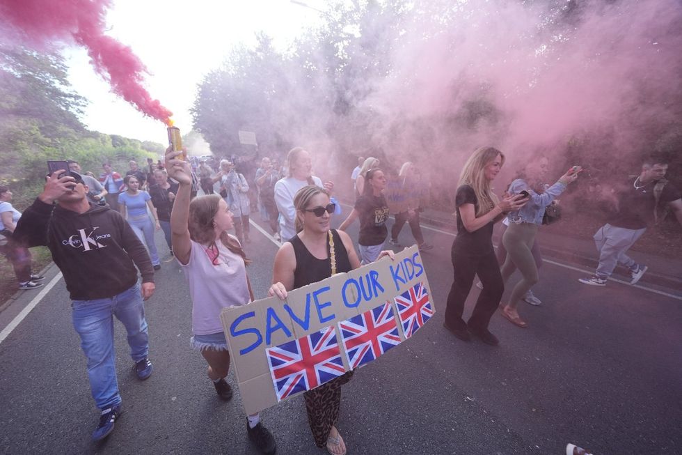 \u200bProtesters lit flares and marched on the hotel