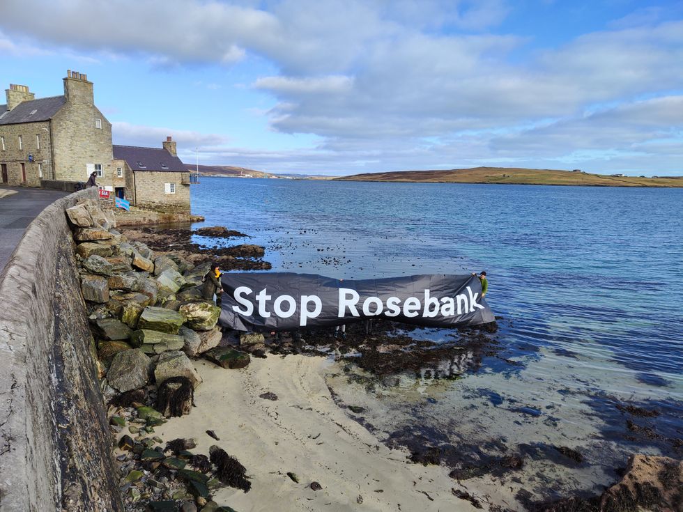 \u200bProtesters unveiled a "Stop Rosebank" banner