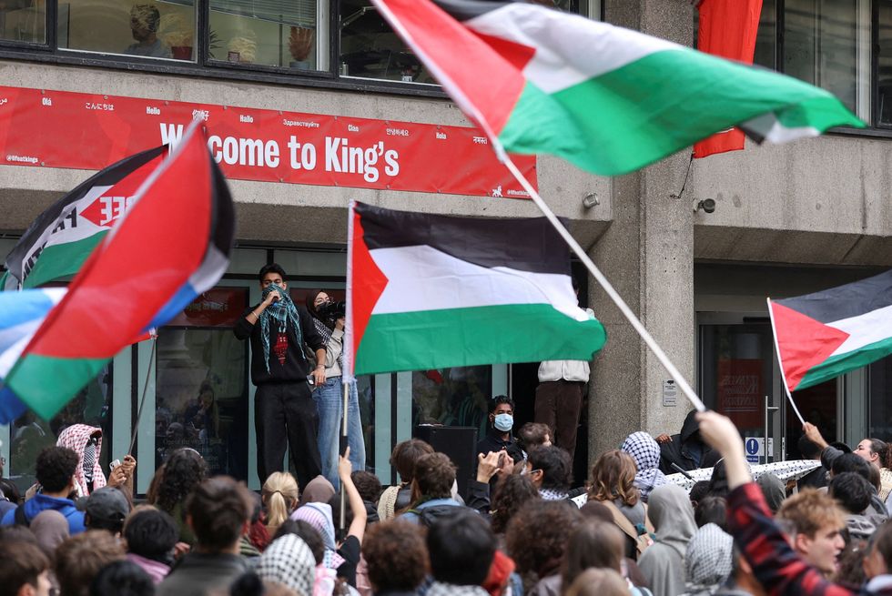 \u200bProtesters wave flags as students take part in an inter-university march in support of Palestinians
