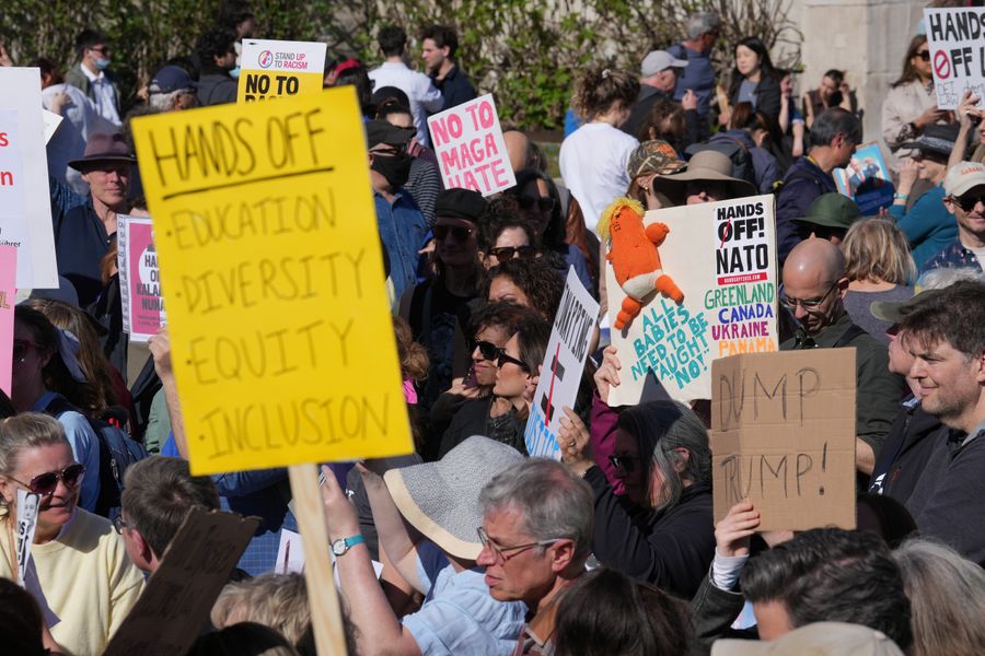 \u200bProtesters wielded signs reading 'hands off'