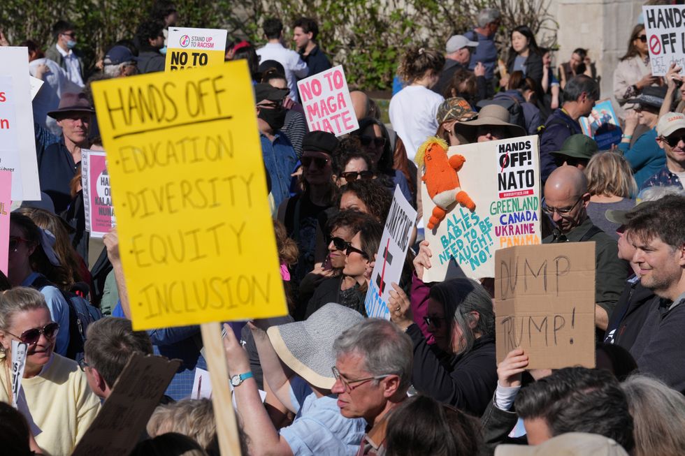 \u200bProtesters wielded signs reading 'hands off'