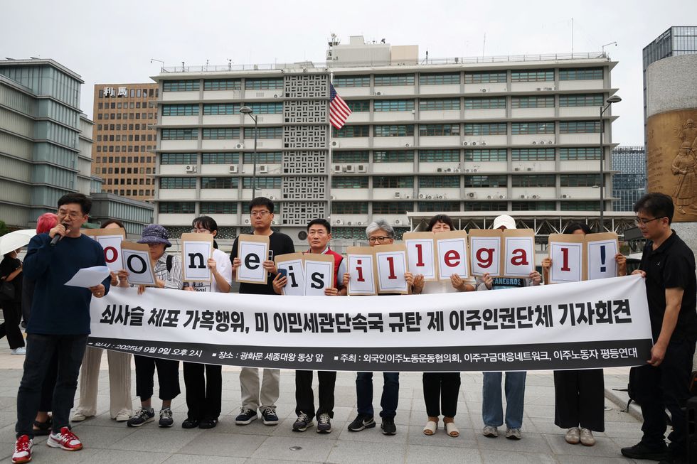 \u200bProtesters with a 'No one is illegal' banner in South Korea
