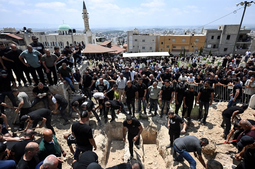 \u200bRelatives and friends attend the funeral of Manar Khatib, her two daughters Hala and Shada, and their relative Manal Khatib, who were killed during a missile attack from Iran on Israel