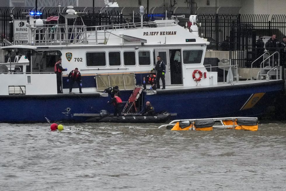 \u200bRescue workers and emergency personnel work at the scene of a helicopter crash on the Hudson River