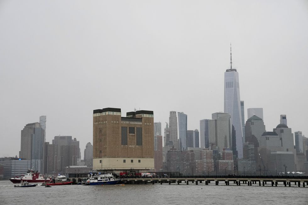 \u200bRescue workers and emergency personnel work at the scene of a helicopter crash