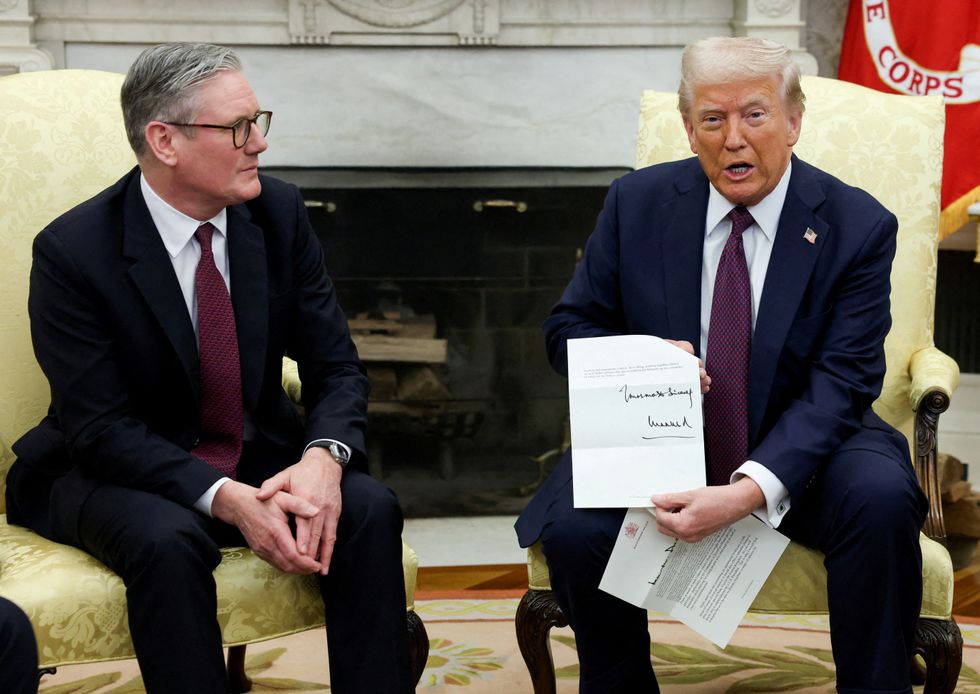 \u200bresident Donald Trump holds a letter from Britain's King Charles