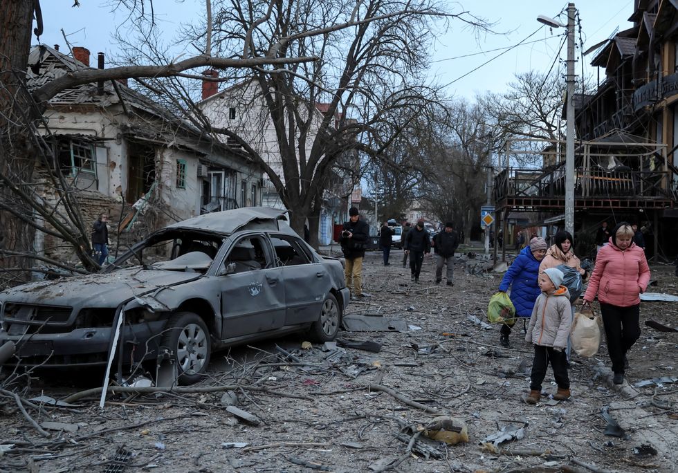 \u200bResidents leave from a site of apartment buildings hit by a Russian air strike
