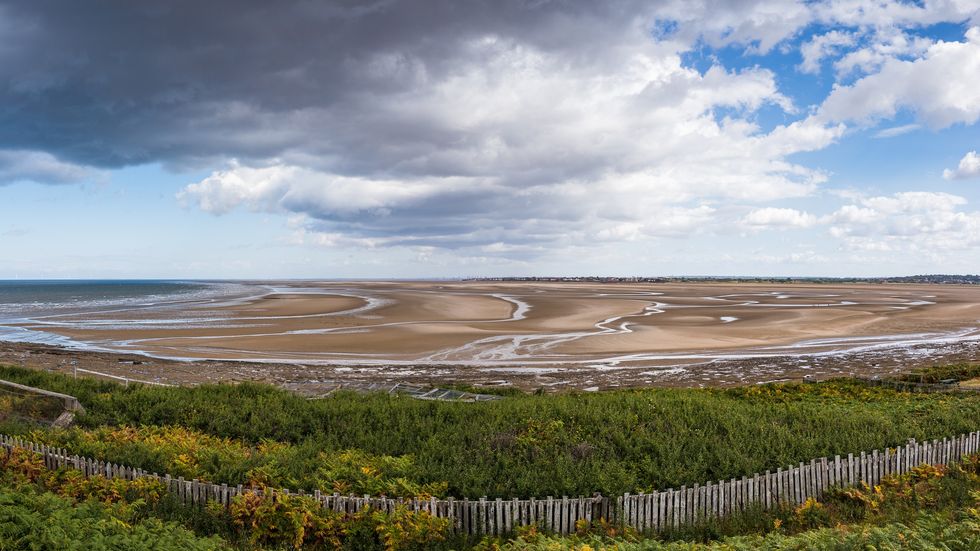 \u200bRhe beach at Holylake, seen from Hilbre Island in the Dee Estuary.