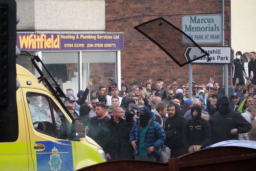 \u200bRiot police hold back protesters after disorder broke out in Southport