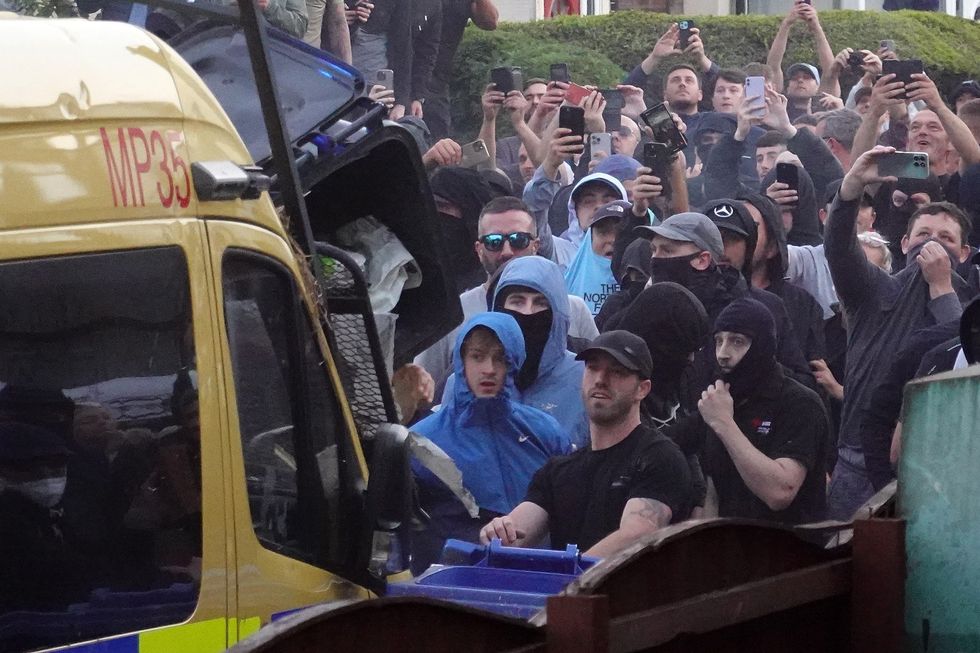 \u200bRiot police hold back protesters after disorder broke out